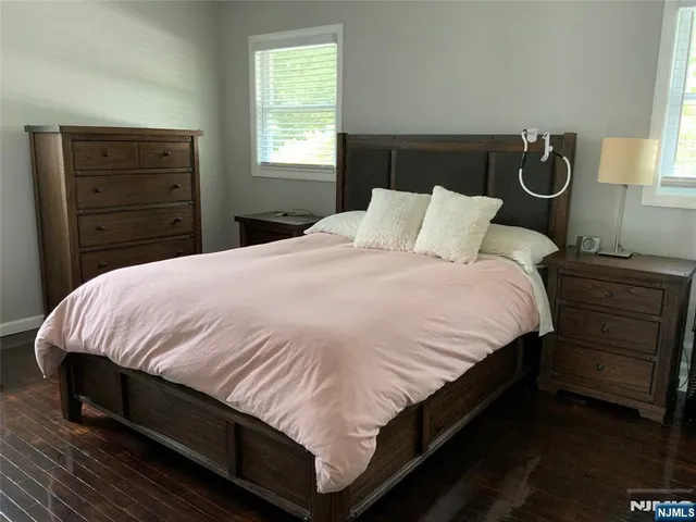 a large bed sitting in a bedroom next to a window