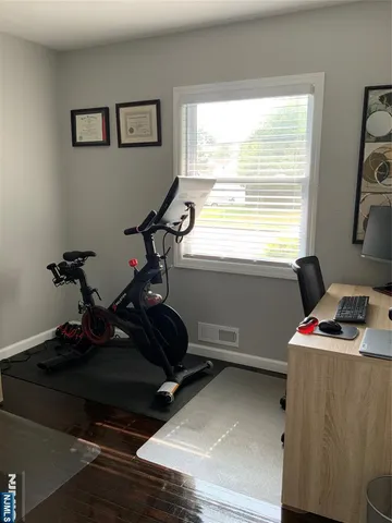 a room with gym equipment and a window