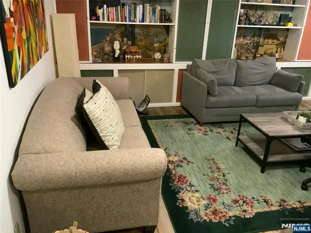 a living room with furniture and a floor to ceiling window