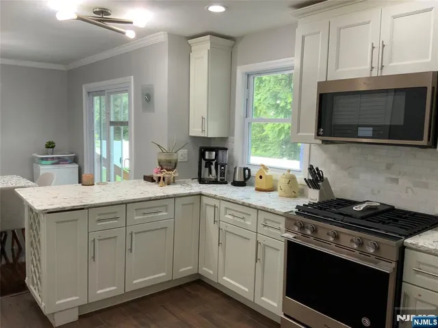 a kitchen with a sink stove and microwave