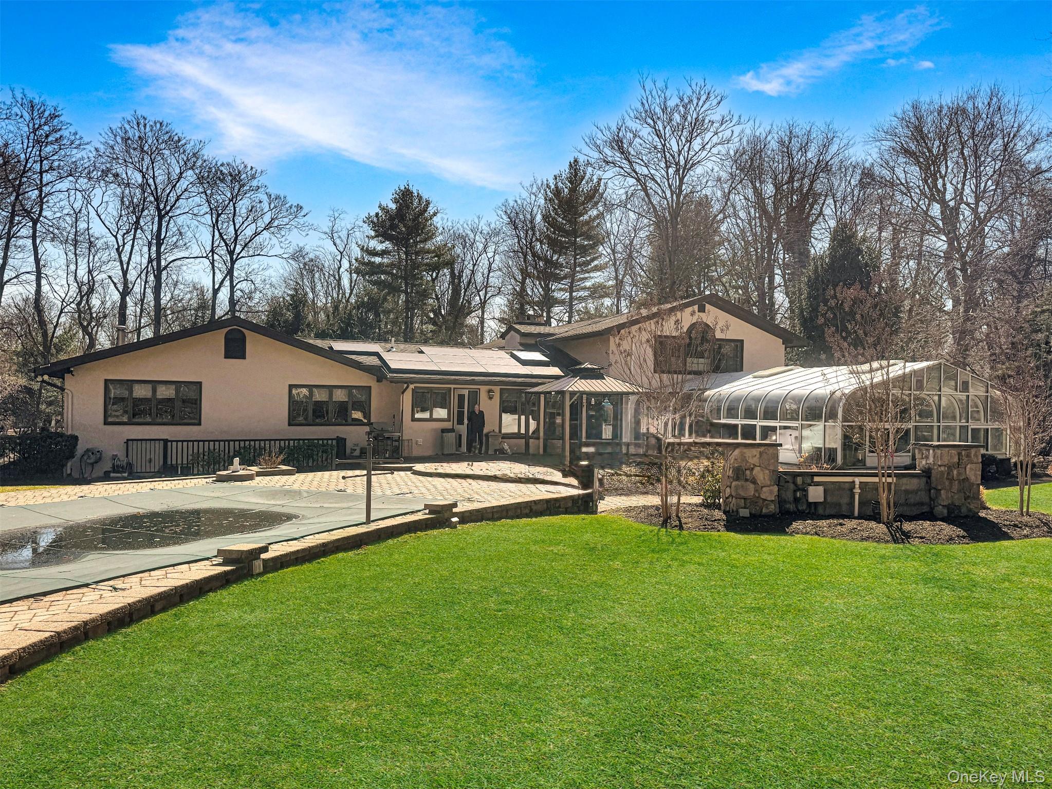a front view of a house with a yard table and chairs