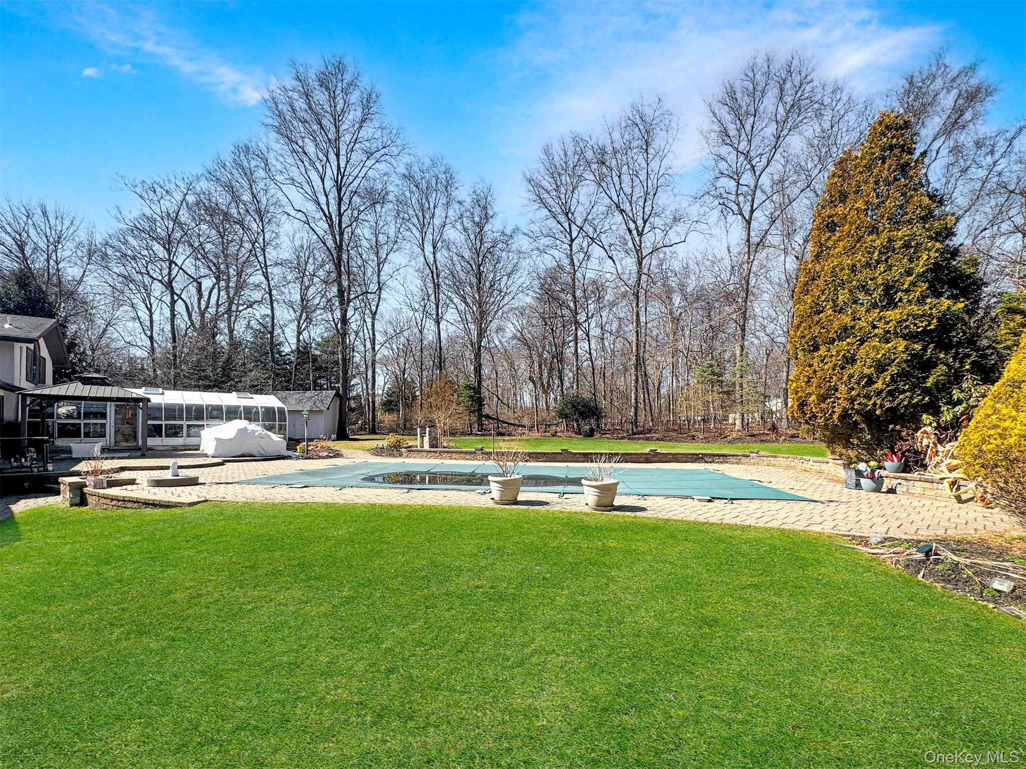 37 Bridle Path St. James, NY 11780 - Photo 37 of 38 a view of back yard with swimming pool and seating space