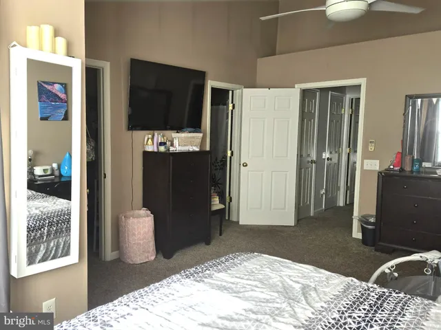 a bedroom with a bed and a mirror