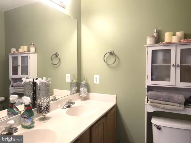 a bathroom with a sink vanity and a mirror