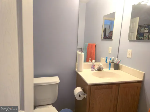 a bathroom with a sink mirror and toilet