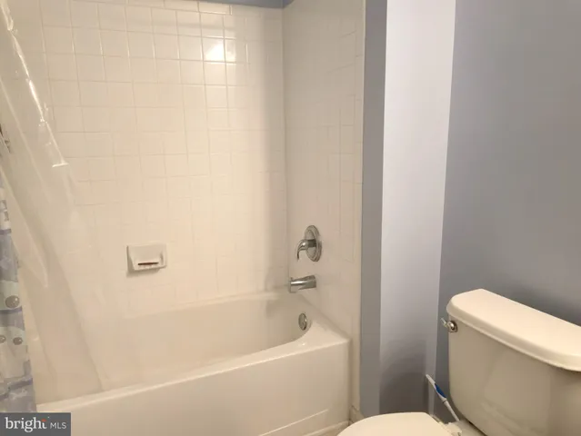 a white bath tub sitting next to a white toilet