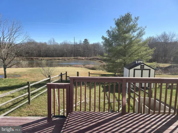 a view of a wooden deck with lake view
