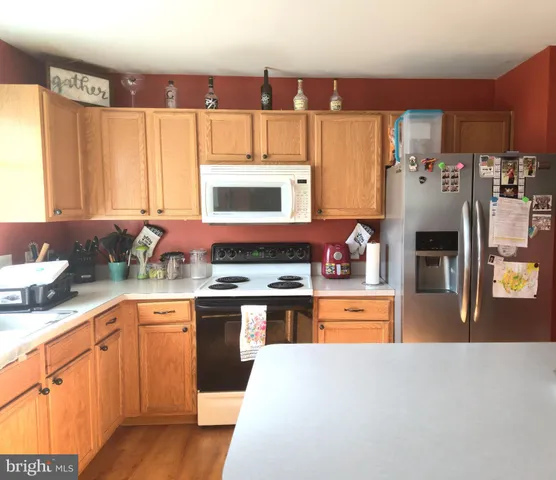 a kitchen with stainless steel appliances granite countertop a sink and cabinets