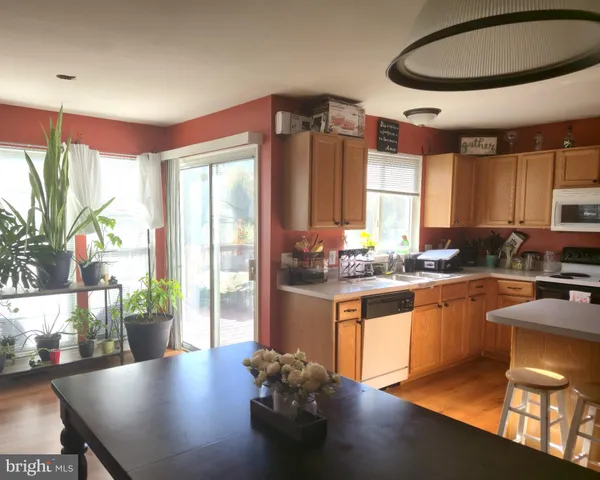 a kitchen with stainless steel appliances granite countertop a stove and a refrigerator