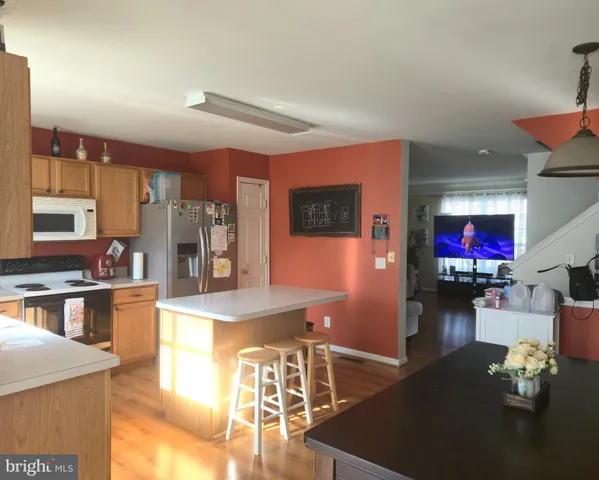 a kitchen with stainless steel appliances granite countertop a refrigerator and a stove
