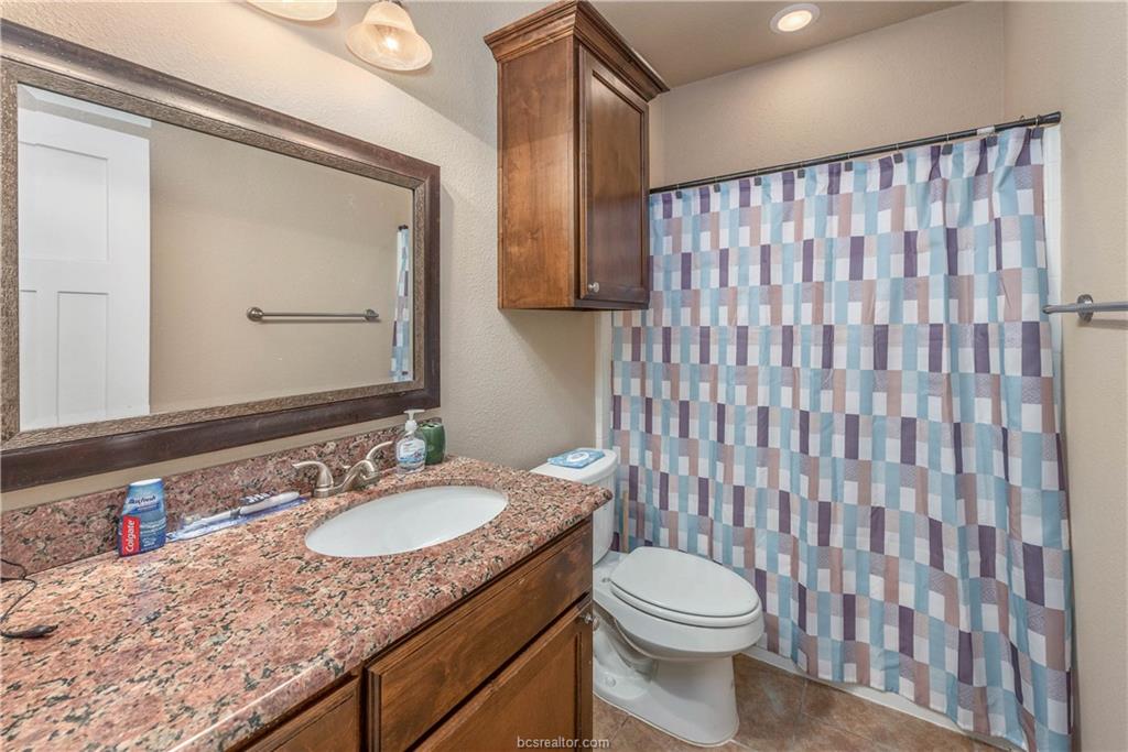 3621 Haverford Road College Station, TX 77845 - Photo 14 of 24 a bathroom with a granite countertop sink toilet and mirror