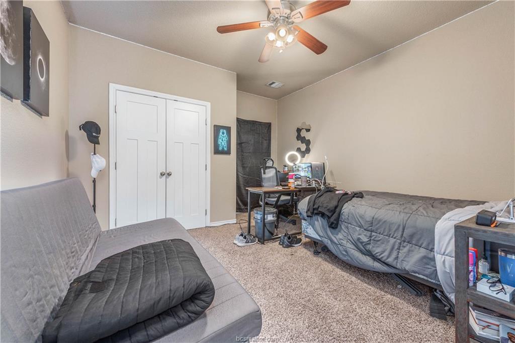 3621 Haverford Road College Station, TX 77845 - Photo 15 of 24 a bedroom with furniture and a chandelier