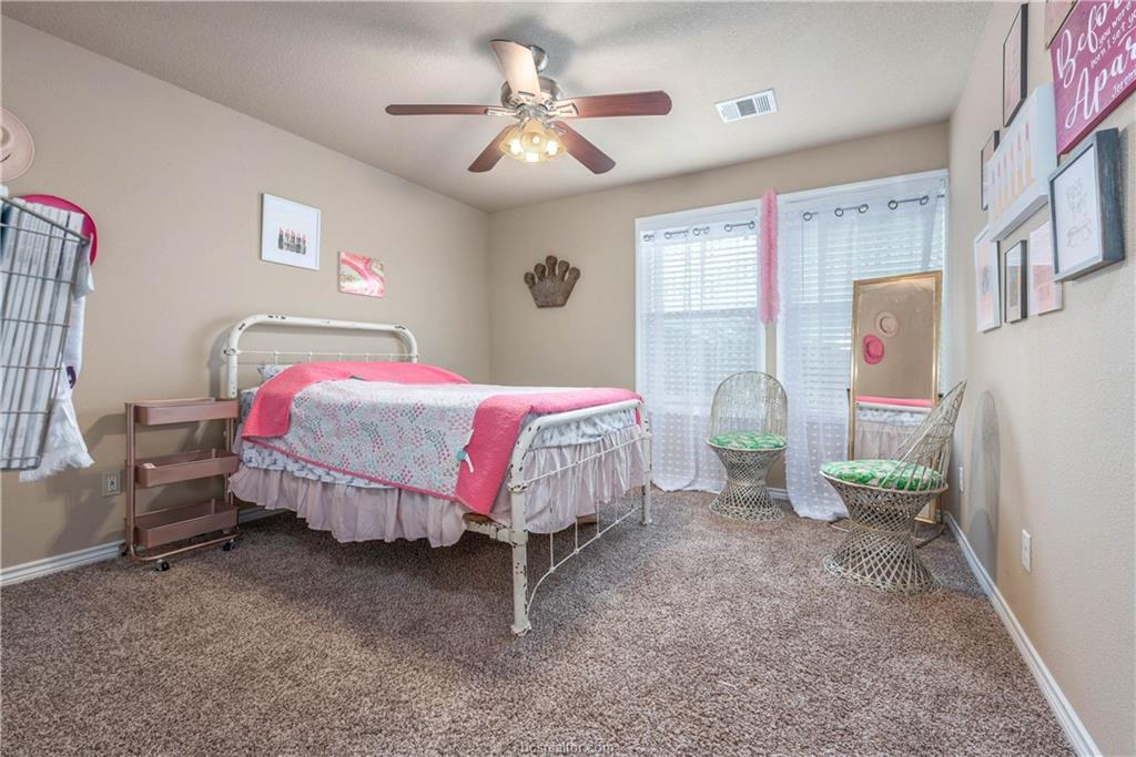 3621 Haverford Road College Station, TX 77845 - Photo 18 of 24 a bed room with a bed and a chandelier