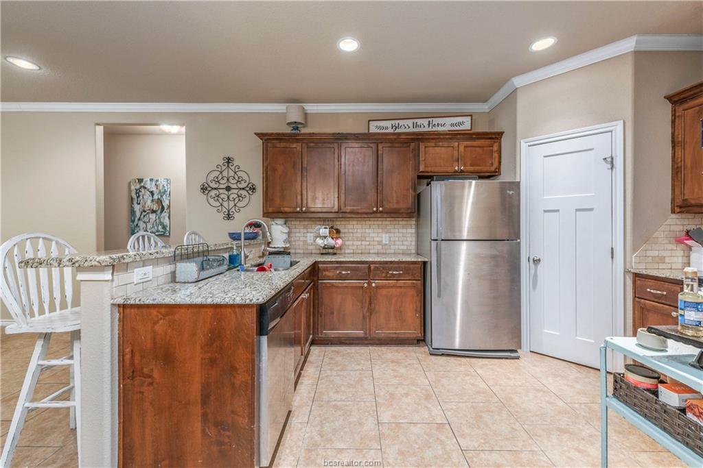 3621 Haverford Road College Station, TX 77845 - Photo 8 of 24 a kitchen with refrigerator and cabinets