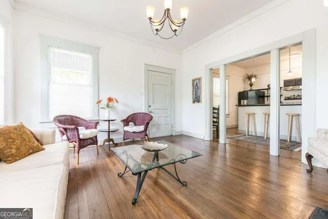 a living room with furniture dining table and wooden floor