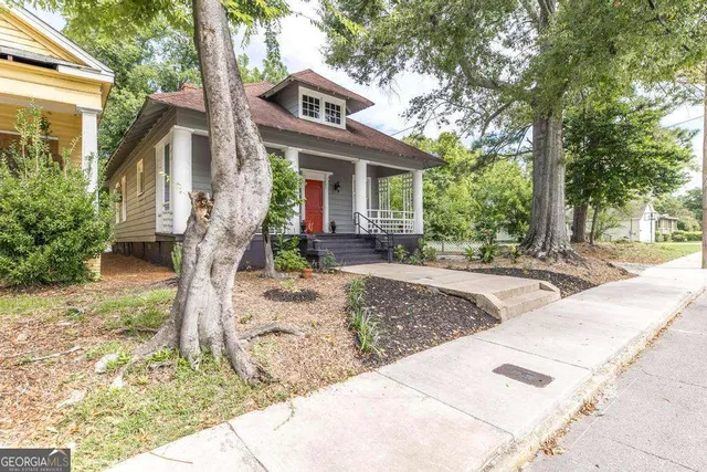 a front view of a house with garden