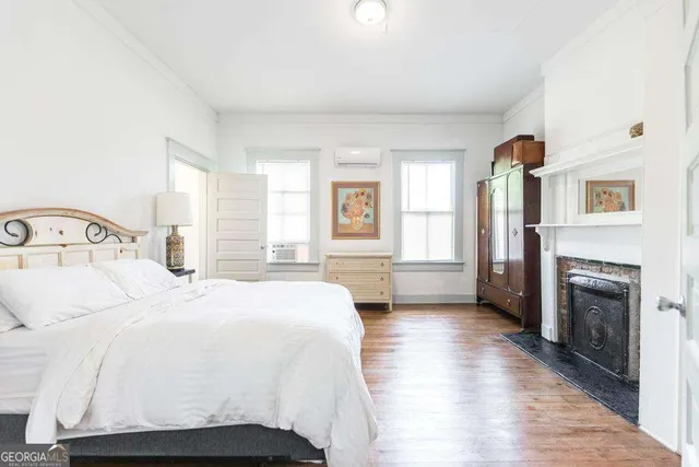 a bedroom with a bed and a fireplace