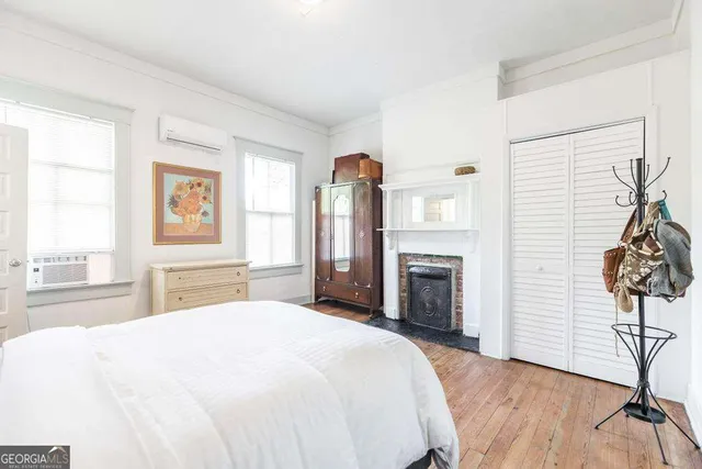 a spacious bedroom with a bed and a chandelier