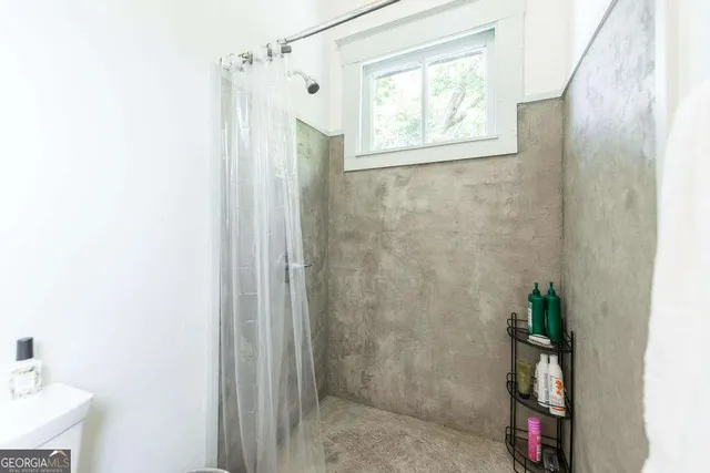 a bathroom with a shower and a window