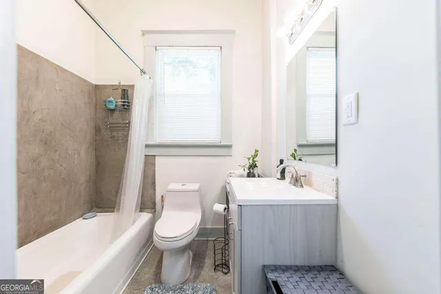 a bathroom with a toilet a sink and bathtub