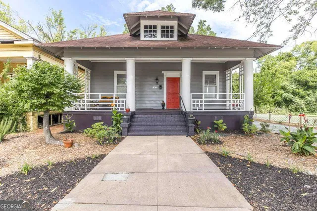 a front view of a house with a garden