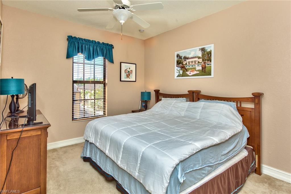 9102 Capistrano Street South, Unit 7209 Naples, FL 34113 - Photo 13 of 25 a bedroom with a bed and a window