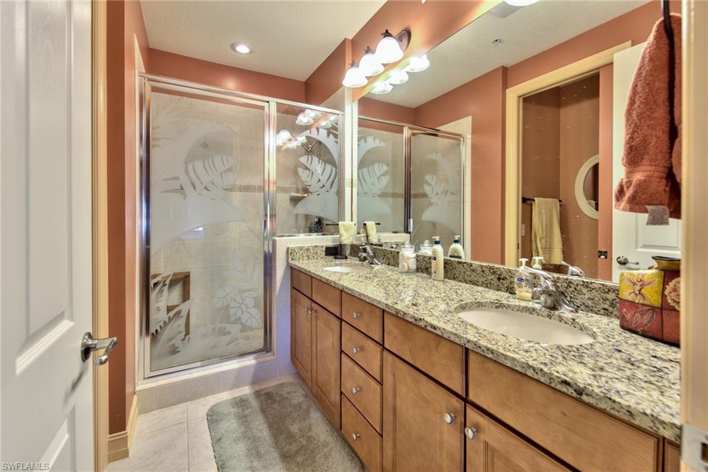 9102 Capistrano Street South, Unit 7209 Naples, FL 34113 - Photo 14 of 25 a bathroom with a granite countertop sink mirror and double