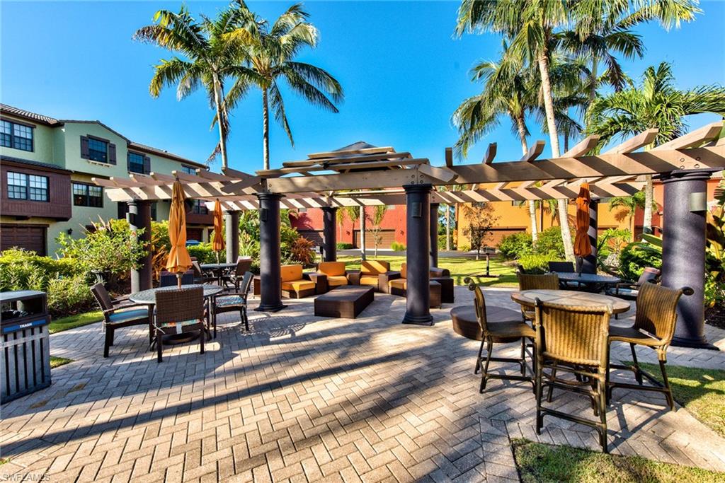 9102 Capistrano Street South, Unit 7209 Naples, FL 34113 - Photo 16 of 25 a view of a chairs and tables in patio