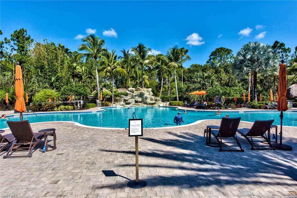 9102 Capistrano Street South, Unit 7209 Naples, FL 34113 - Photo 19 of 25 a view of a garden with sitting area