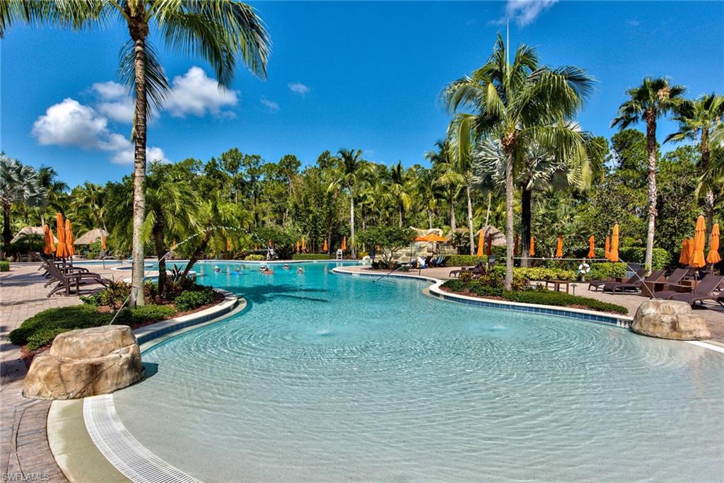 9102 Capistrano Street South, Unit 7209 Naples, FL 34113 - Photo 22 of 25 a view of a swimming pool with a yard
