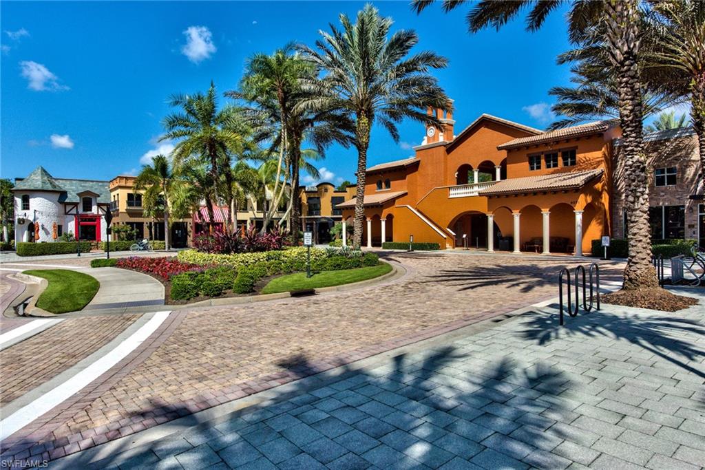 9102 Capistrano Street South, Unit 7209 Naples, FL 34113 - Photo 23 of 25 a view of a white house with a yard