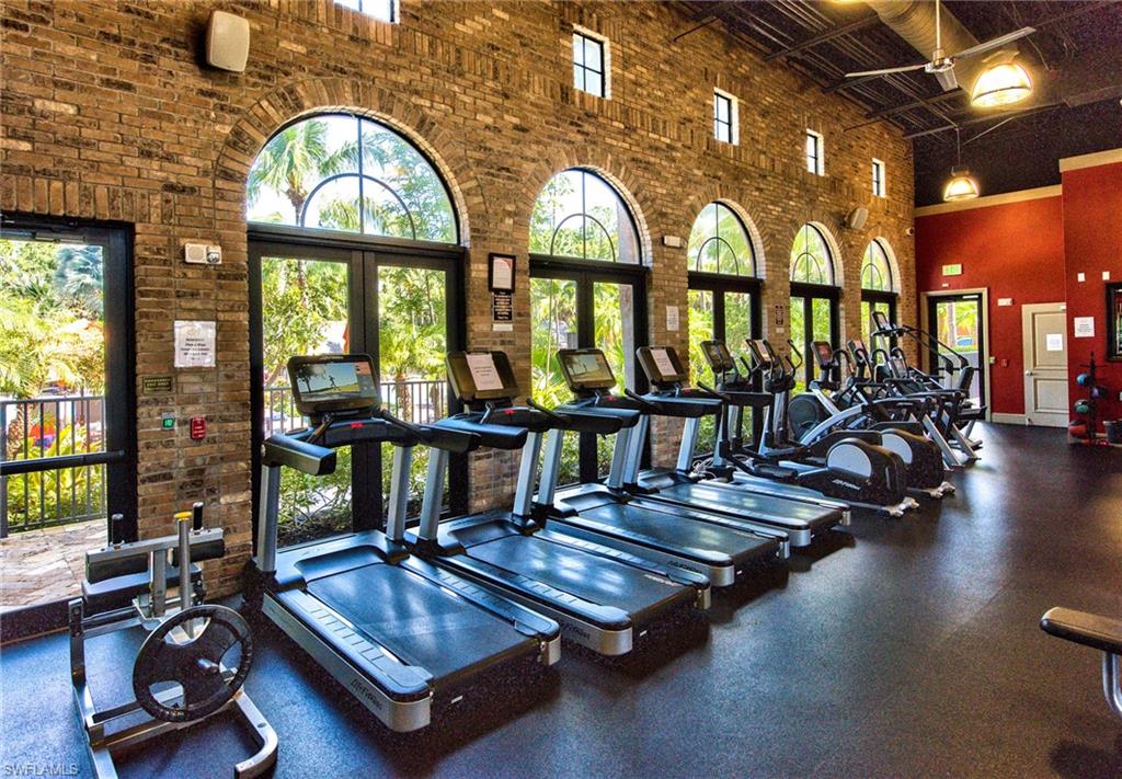9102 Capistrano Street South, Unit 7209 Naples, FL 34113 - Photo 24 of 25 a living room with furniture pool table and a large window