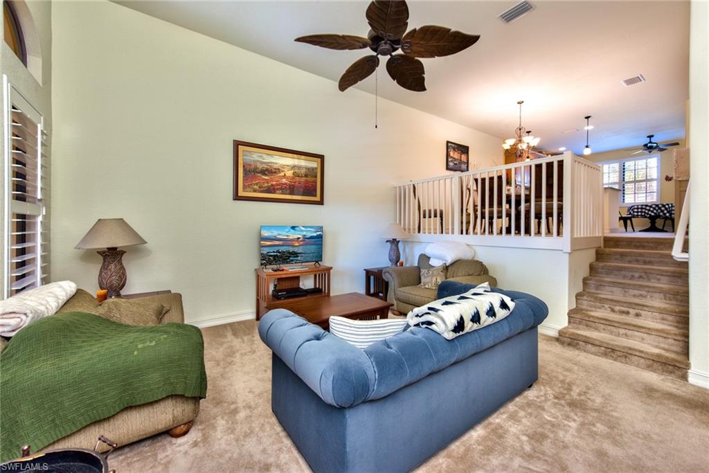 9102 Capistrano Street South, Unit 7209 Naples, FL 34113 - Photo 5 of 25 a living room with furniture and a ceiling fan