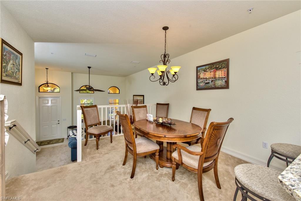 9102 Capistrano Street South, Unit 7209 Naples, FL 34113 - Photo 6 of 25 a view of a dining room with furniture