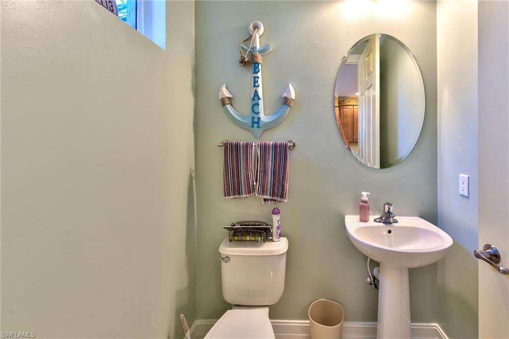 9102 Capistrano Street South, Unit 7209 Naples, FL 34113 - Photo 9 of 25 a bathroom with a sink and a mirror