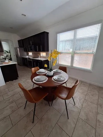 a view of a dining table and chairs in a room