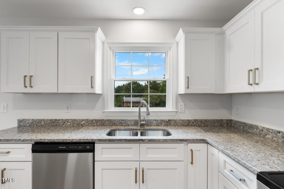 332 Gunn Poole Road Mebane, NC 27302 - Photo 11 of 27 a kitchen with granite countertop white cabinets and a window