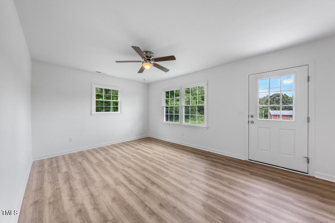 332 Gunn Poole Road Mebane, NC 27302 - Photo 3 of 27 a view of empty room with wooden floor and fan