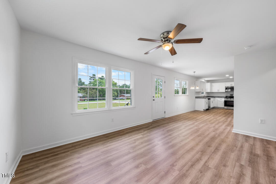 332 Gunn Poole Road Mebane, NC 27302 - Photo 4 of 27 a view of a kitchen with wooden floor and a window
