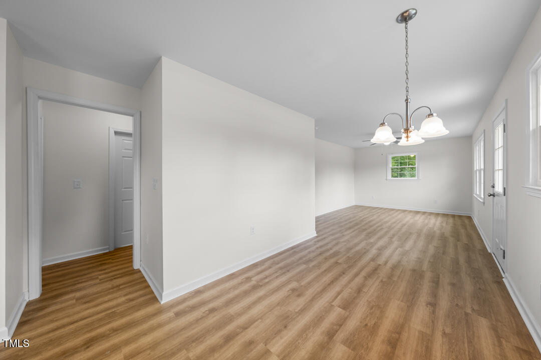332 Gunn Poole Road Mebane, NC 27302 - Photo 6 of 27 a view of empty room with wooden floor and ceiling fan
