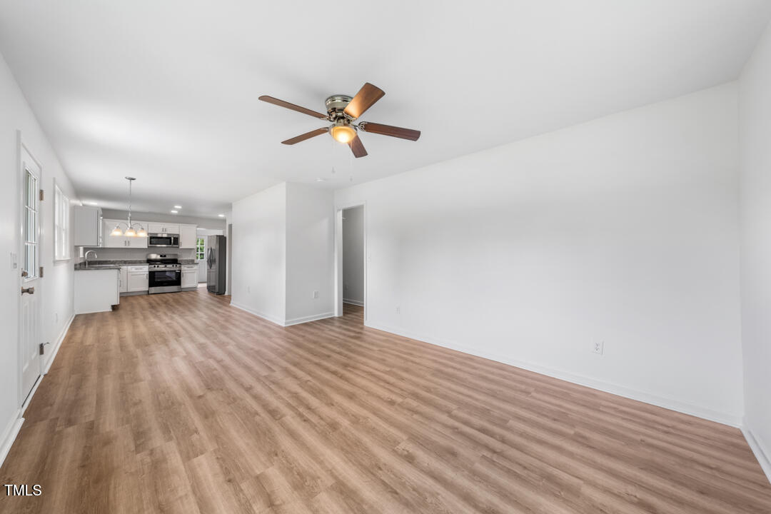 332 Gunn Poole Road Mebane, NC 27302 - Photo 8 of 27 a view of empty room with wooden floor and ceiling fan
