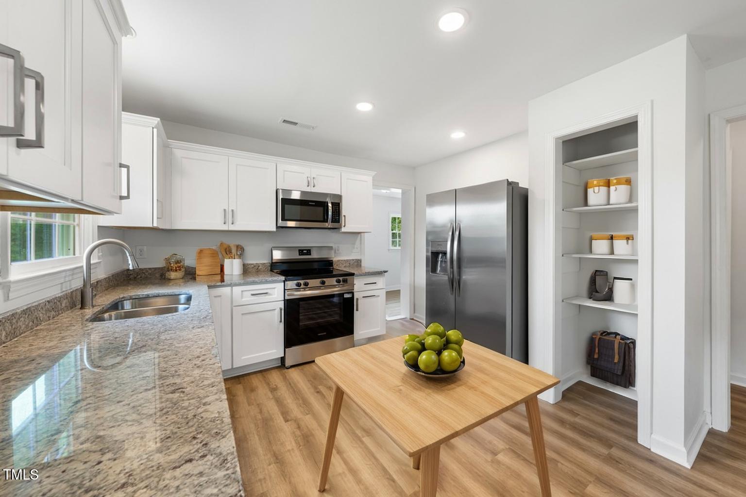 332 Gunn Poole Road Mebane, NC 27302 - Photo 9 of 27 a kitchen with stainless steel appliances granite countertop a refrigerator a stove top oven a sink and dishwasher