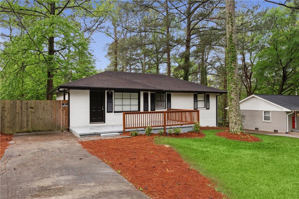 3675 Daisy Drive Decatur, GA 30032 - Photo 1 of 1 a front view of a house with a garden and trees