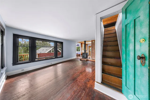 wooden floor in an empty room with a window