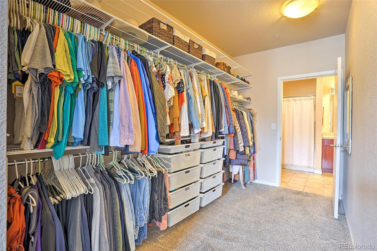 3101 Blake Street, Unit 214 Denver, CO 80205 - Photo 14 of 25 a view of walk in closet with clothes and shoes