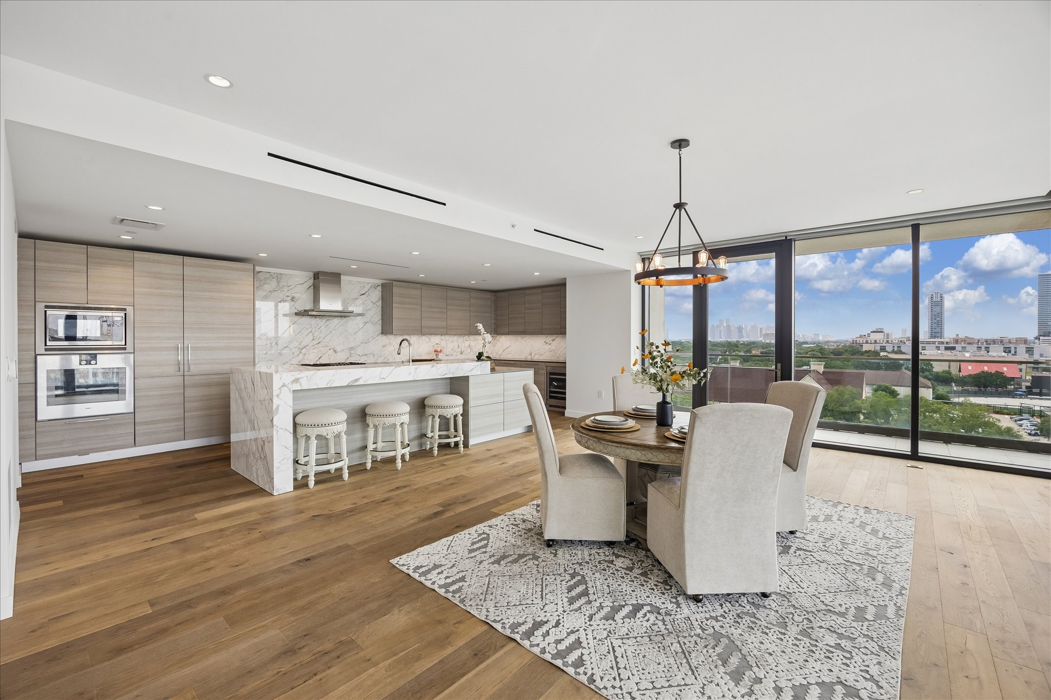 3433 Westheimer Road, Unit 702 Houston, TX 77027 - Photo 2 of 48 Downtown views from your dining room. Open-concept kitchen and dining area features Poggenpohl cabinetry that seamlessly integrates the refrigerator and dishwasher for a sophisticated, streamlined aesthetic.