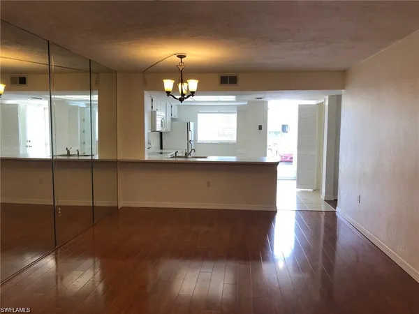 a view of a kitchen with a sink and wooden floor