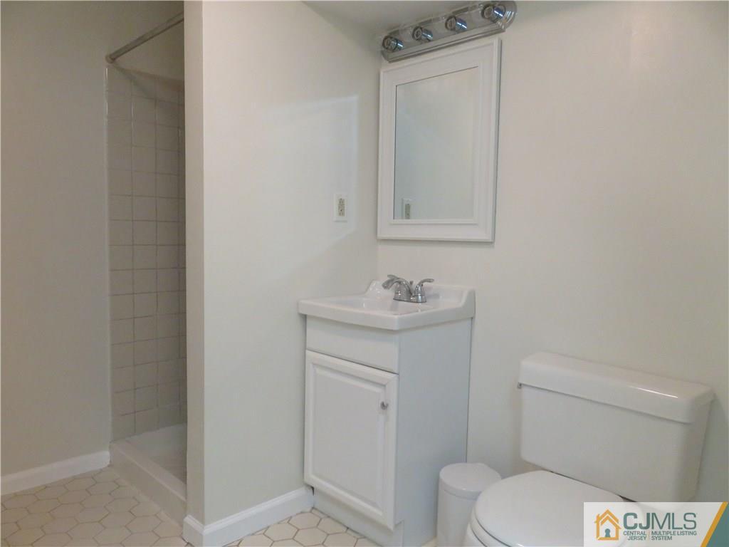 55 Primrose Circle Princeton, NJ 08540 - Photo 18 of 24 a bathroom with a toilet sink vanity and mirror