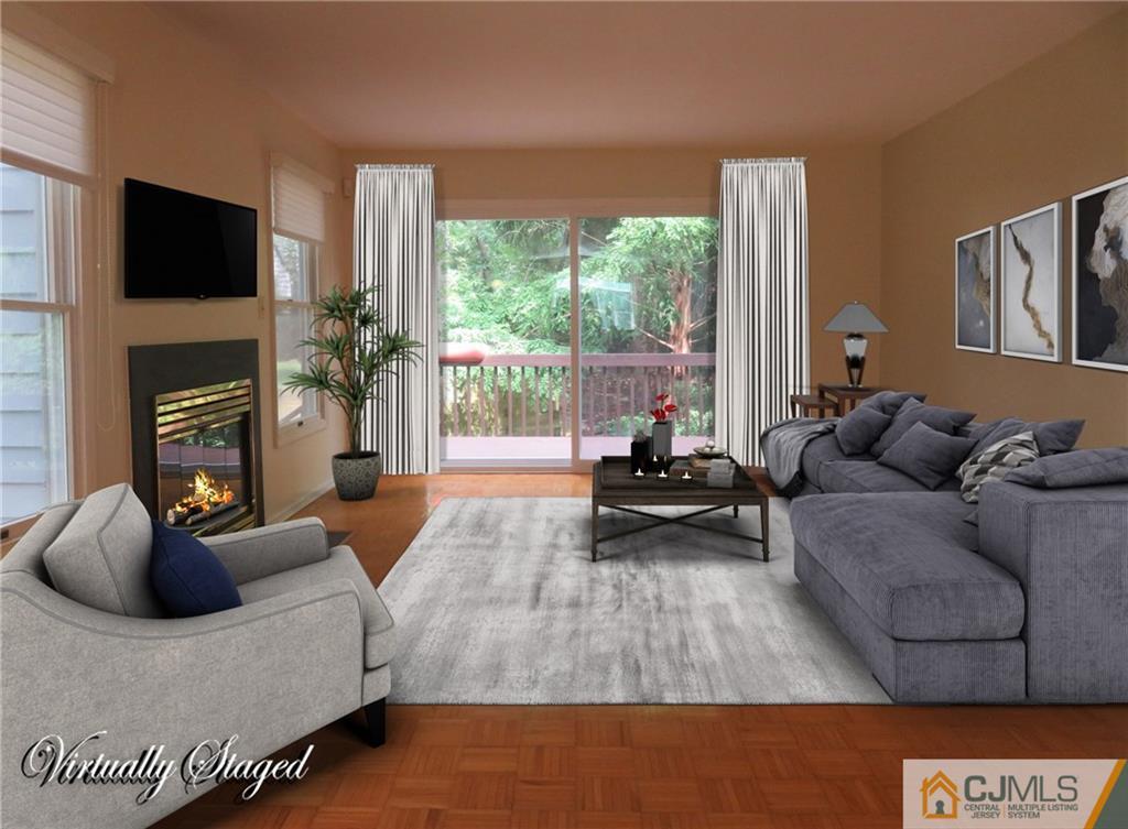 55 Primrose Circle Princeton, NJ 08540 - Photo 6 of 24 a living room with furniture a flat screen tv and a fireplace