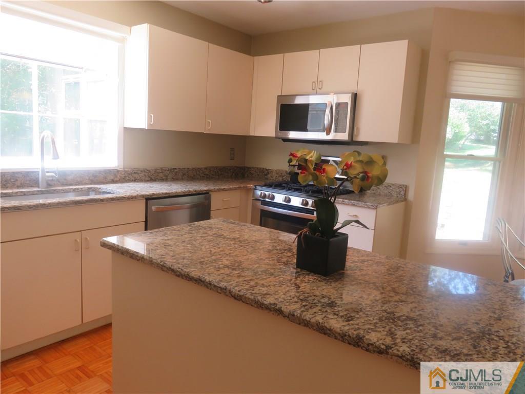 55 Primrose Circle Princeton, NJ 08540 - Photo 8 of 24 a kitchen with a sink a stove and microwave